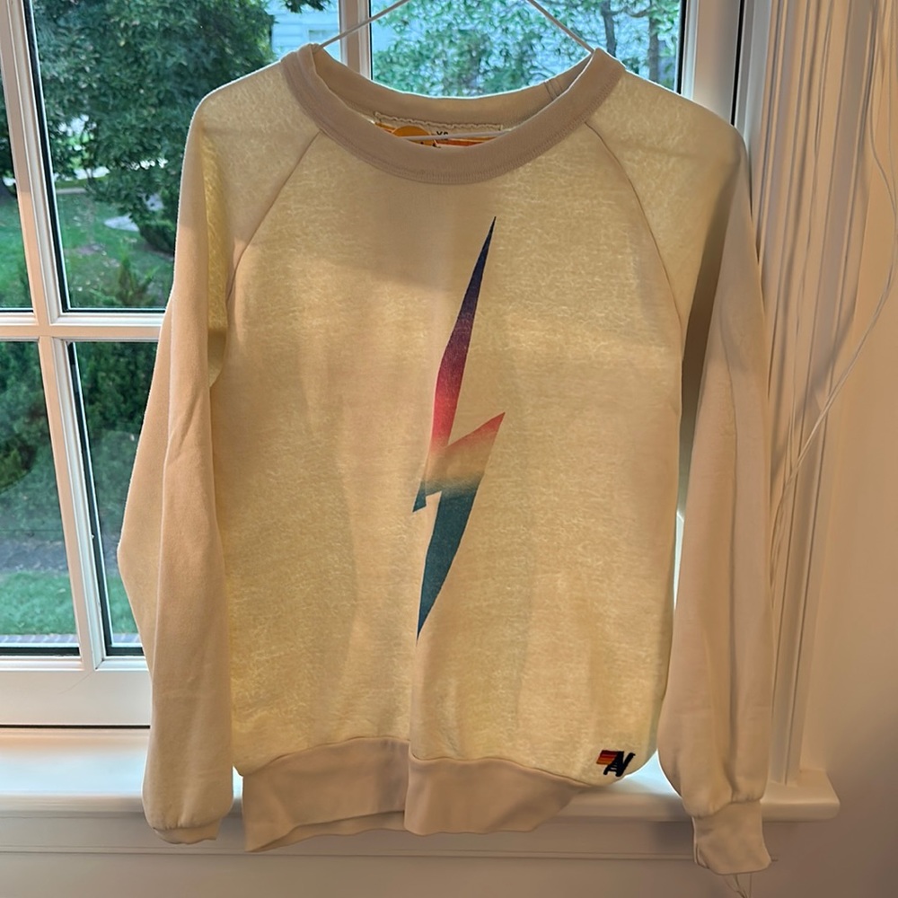 Cream Aviator National crewneck with rainbow lighting bolt